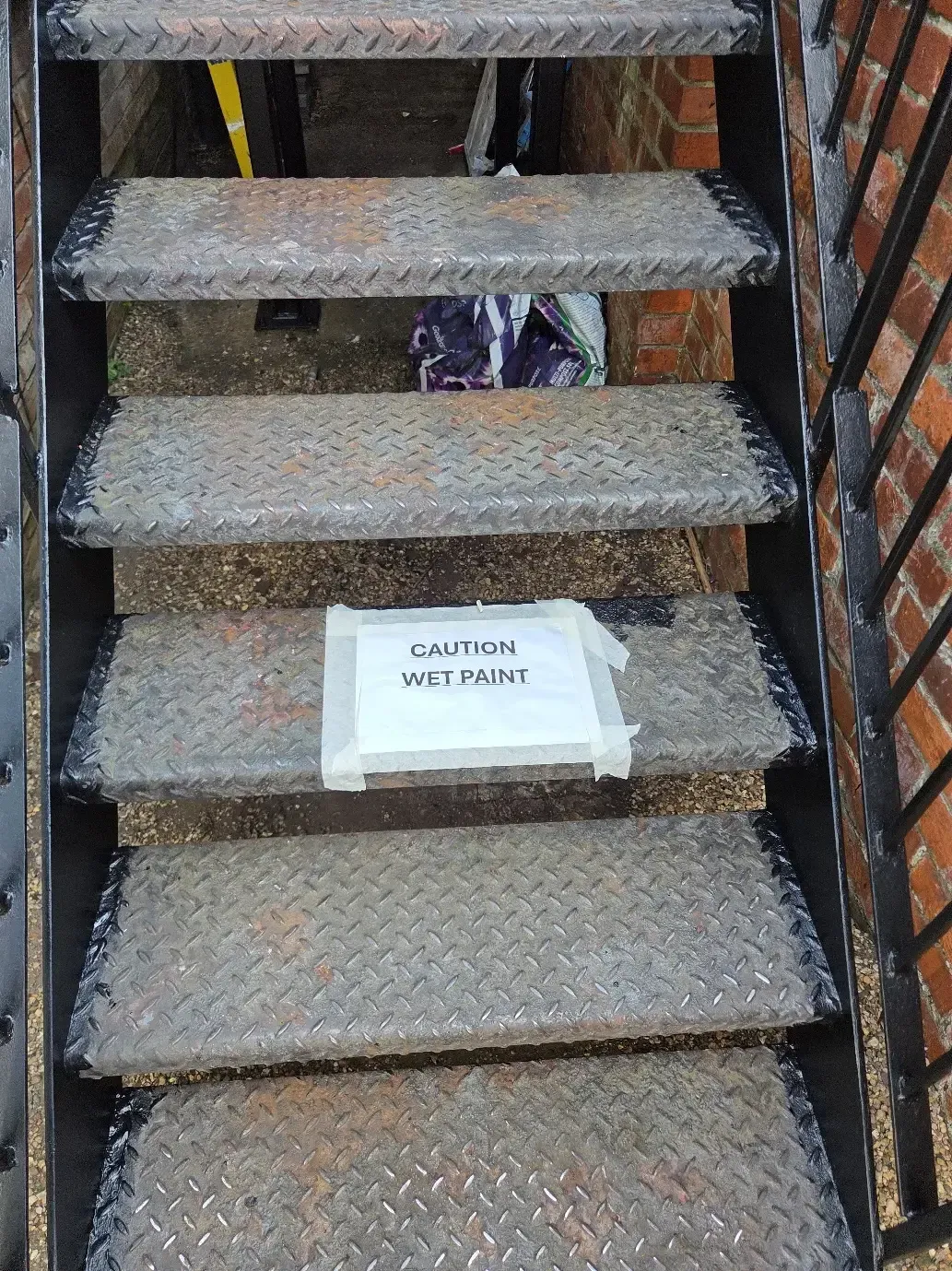 Corroded steel staircase treads before surface preparation.